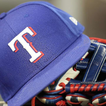 Jul 26, 2024; Toronto, Ontario, CAN; A hat and glove of a Texas Rangers player during a game against the Toronto Blue Jays at Rogers Centre. Mandatory Credit: John E. Sokolowski-Imagn Images
