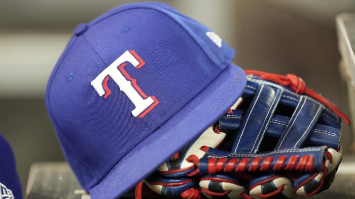 Jul 26, 2024; Toronto, Ontario, CAN; A hat and glove of a Texas Rangers player during a game against the Toronto Blue Jays at Rogers Centre. Mandatory Credit: John E. Sokolowski-USA TODAY Sports