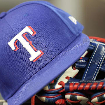 Jul 26, 2024; Toronto, Ontario, CAN; A hat and glove of a Texas Rangers player during a game against the Toronto Blue Jays at Rogers Centre. 