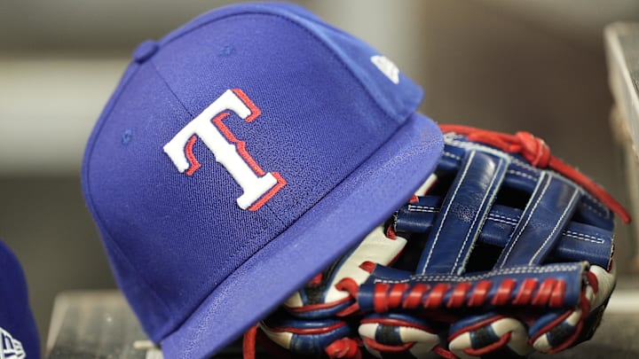 Jul 26, 2024; Toronto, Ontario, CAN; A hat and glove of a Texas Rangers player during a game against the Toronto Blue Jays at Rogers Centre. 