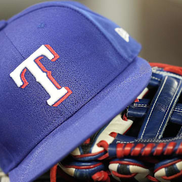 Jul 26, 2024; Toronto, Ontario, CAN; A hat and glove of a Texas Rangers player during a game against the Toronto Blue Jays at Rogers Centre