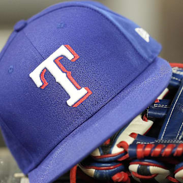Jul 26, 2024; Toronto, Ontario, CAN; A hat and glove of a Texas Rangers player during a game against the Toronto Blue Jays at Rogers Centre.