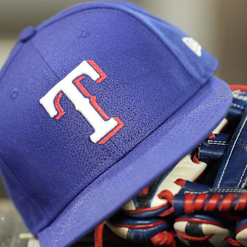 Jul 26, 2024; Toronto, Ontario, CAN; A hat and glove of a Texas Rangers player during a game against the Toronto Blue Jays at Rogers Centre. Mandatory Credit: John E. Sokolowski-Imagn Images