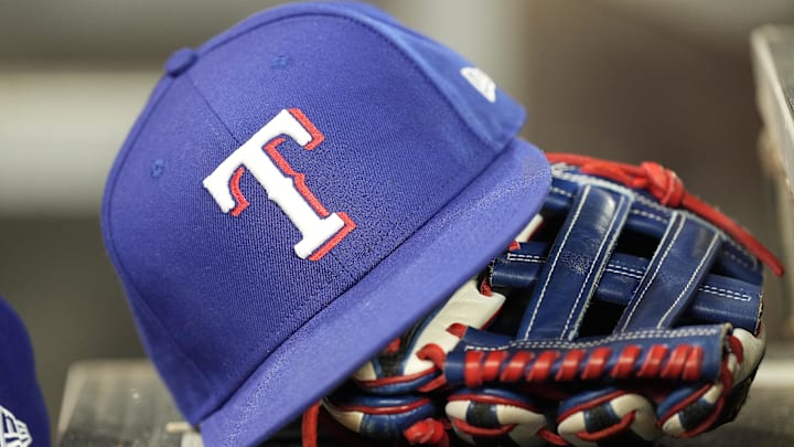 Jul 26, 2024; Toronto, Ontario, CAN; A hat and glove of a Texas Rangers player during a game against the Toronto Blue Jays at Rogers Centre. Mandatory Credit: John E. Sokolowski-Imagn Images