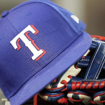 Jul 26, 2024; Toronto, Ontario, CAN; A hat and glove of a Texas Rangers player during a game against the Toronto Blue Jays at Rogers Centre.