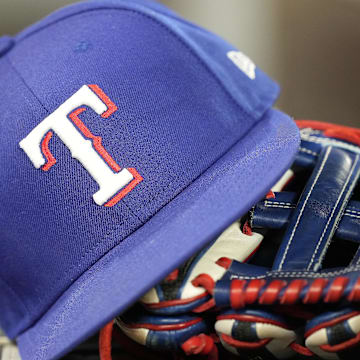 Jul 26, 2024; Toronto, Ontario, CAN; A hat and glove of a Texas Rangers player during a game against the Toronto Blue Jays at Rogers Centre. 