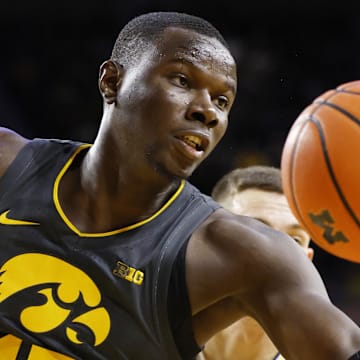 Dec 7, 2024; Ann Arbor, Michigan, USA;  Iowa Hawkeyes forward Ladji Dembele (13) grabs the rebound in the first half against the Michigan Wolverines at Crisler Center. Mandatory Credit: Rick Osentoski-Imagn Images