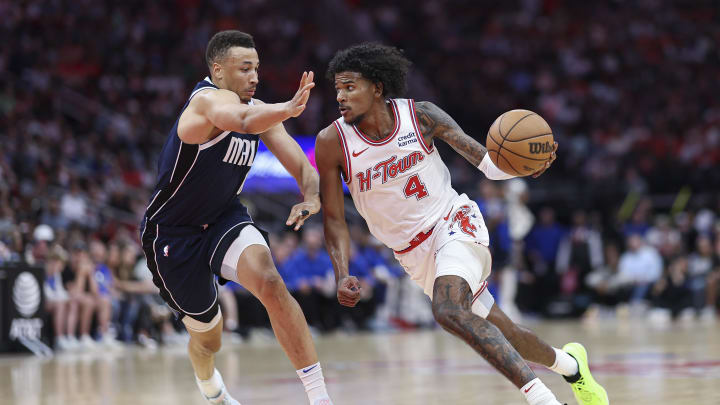 Mar 31, 2024; Houston, Texas, USA; Houston Rockets guard Jalen Green (4) drives with the ball as Dallas Mavericks guard Dante Exum (0) defends during the second quarter at Toyota Center. Mandatory Credit: Troy Taormina-USA TODAY Sports