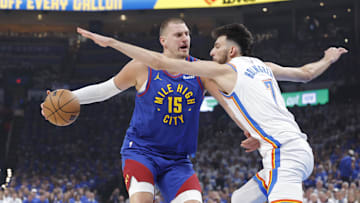 May 13, 2025; Oklahoma City, Oklahoma, USA; Denver Nuggets center Nikola Jokic (15) is defended by Oklahoma City Thunder forward Chet Holmgren (7) on a drive during the first quarter of game five of the second round for the 2025 NBA Playoffs at Paycom Center. Mandatory Credit: Alonzo Adams-Imagn Images