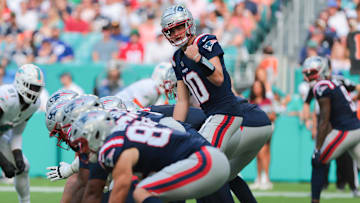 Nov 24, 2024; Miami Gardens, Florida, USA; New England Patriots quarterback Drake Maye (10) reacts from the line of scrimmage against the Miami Dolphins during the first quarter at Hard Rock Stadium. Mandatory Credit: Sam Navarro-Imagn Images