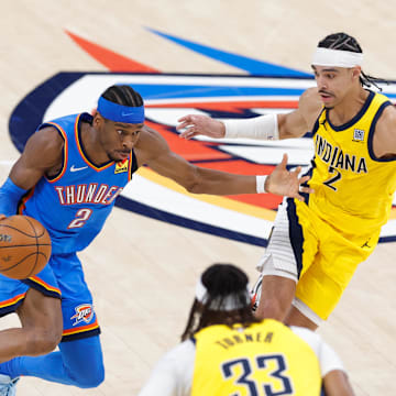 Jun 22, 2025; Oklahoma City, Oklahoma, USA; Oklahoma City Thunder guard Shai Gilgeous-Alexander (2) dribbles the ball against Indiana Pacers guard Andrew Nembhard (2) during the first half of game seven of the 2025 NBA Finals at Paycom Center. Mandatory Credit: Alonzo Adams-Imagn Images