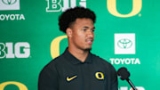 Oregon Ducks tight end Kenyon Sadiq and reporter Bri Amaranthus