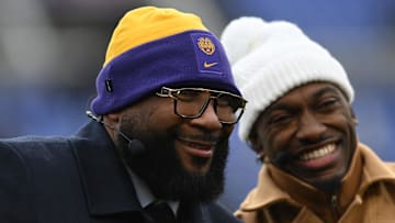 Jan 20, 2024; Baltimore, MD, USA; ESPN NFL analyst Marcus Spears (left) and college football and NFL analyst Robert Griffin III (right) react on the sidelines before a 2024 AFC divisional round game between the Houston Texans and the Baltimore Ravens at M&T Bank Stadium.