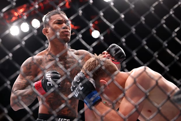 Malcolm Wellmaker (red gloves) fights Cameron Saaiman (blue gloves) during UFC Fight Night at T-Mobile Center.