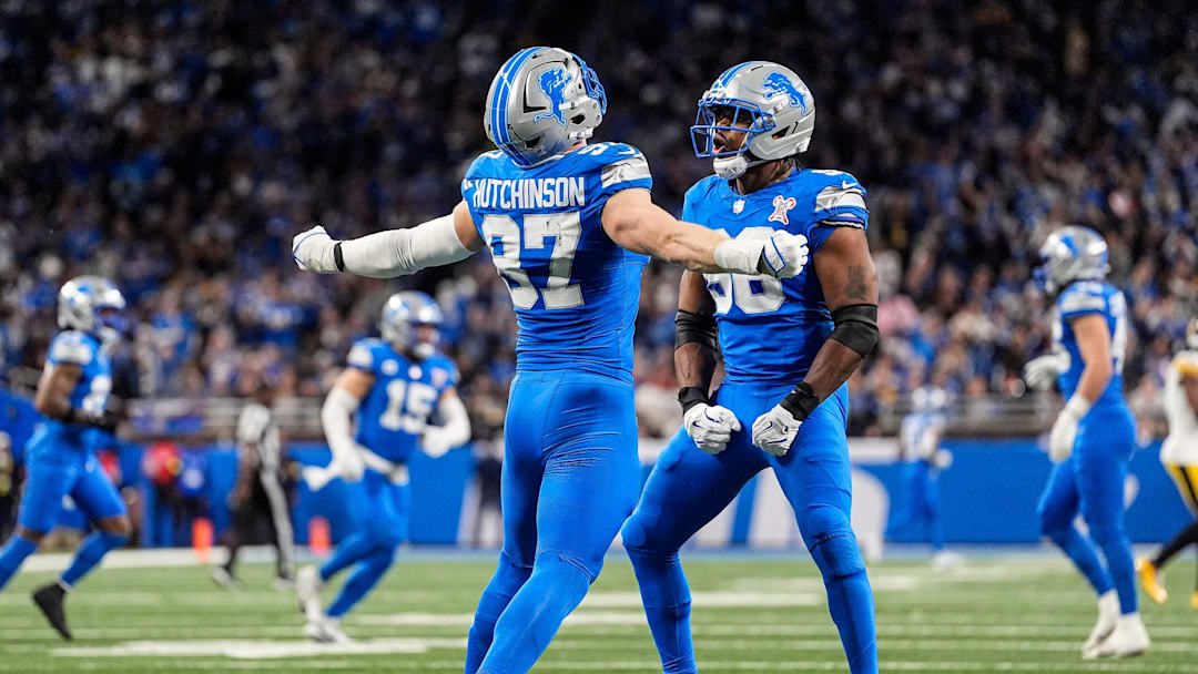 Detroit Lions defensive end Aidan Hutchinson (97) celebrates a sack against Pittsburgh Steelers with linebacker Al-Quadin Muhammad (96) during the first half at Ford Field in Detroit on Sunday, Dec. 21, 2025.