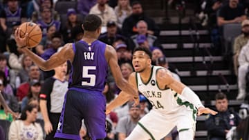 Mar 12, 2024; Sacramento, California, USA; Sacramento Kings guard De'Aaron Fox (5) looks to pass the ball against Milwaukee Bucks forward Giannis Antetokounmpo (34) during the second quarter at Golden 1 Center. Mandatory Credit: Ed Szczepanski-Imagn Images