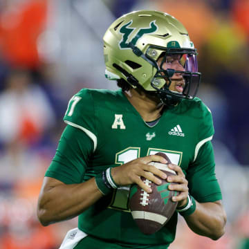 Dec 21, 2023; Boca Raton, FL, USA; South Florida Bulls quarterback Byrum Brown (17) drops back to pass against the Syracuse Orange in the first quarter during the RoofClaim.com Boca Raton Bowl at FAU Stadium. Mandatory Credit: Nathan Ray Seebeck-USA TODAY Sports