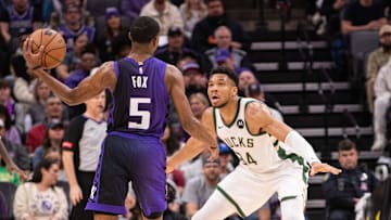 Mar 12, 2024; Sacramento, California, USA; Sacramento Kings guard De'Aaron Fox (5) looks to pass the ball against Milwaukee Bucks forward Giannis Antetokounmpo (34) during the second quarter at Golden 1 Center. Mandatory Credit: Ed Szczepanski-Imagn Images
