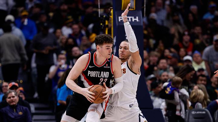Feb 10, 2025; Denver, Colorado, USA; Portland Trail Blazers center Donovan Clingan (23) controls the ball as Denver Nuggets forward Aaron Gordon (32) guards in the third quarter at Ball Arena. Mandatory Credit: Isaiah J. Downing-Imagn Images