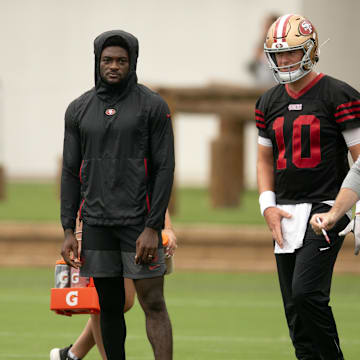 Jul 24, 2025; Santa Clara, CA, USA; San Francisco 49ers wide receiver Brandon Aiyuk (in black hoodie) watches his teammates work out during the second day of training camp. Mandatory Credit: D. Ross Cameron-Imagn Images