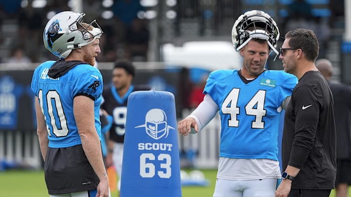 Jul 30, 2024; Charlotte, NC, USA; Carolina Panthers punter Johnny Hekker (10) and long snapper JJ Jansen (44) talk with general manager Dan Morgan during training camp at Carolina Panthers Practice Fields. Mandatory Credit: Jim Dedmon-Imagn Images