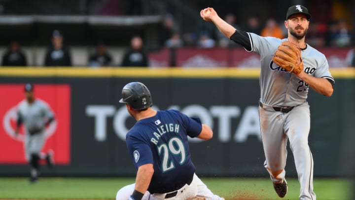 Jun 12, 2024; Seattle, Washington, USA; Chicago White Sox shortstop Paul DeJong (29) throws over Seattle Mariners catcher Cal Raleigh (29) to first base during the fourth inning at T-Mobile Park.