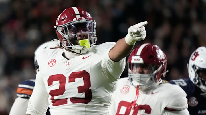 Nov 29, 2025; Auburn, Alabama, USA; Alabama defensive lineman James Smith (23) celebrates his sack of Auburn quarterback Ashton Daniels (12) at Jordan-Hare Stadium. Mandatory Credit: Gary Cosby Jr.-Tuscaloosa News