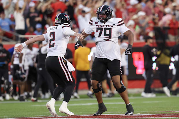 Texas Tech offensive lineman Howard Sampson celebrates with quarterback Behren Morton after a touchdown pass.