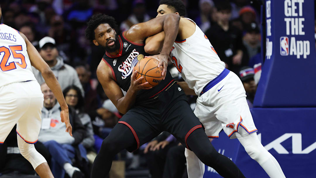 Jan 24, 2026; Philadelphia, Pennsylvania, USA; Philadelphia 76ers center Joel Embiid (21) controls the ball against New York Knicks center Karl-Anthony Towns (32) during the second quarter at Xfinity Mobile Arena. Mandatory Credit: Bill Streicher-Imagn Images