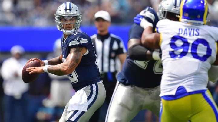 Aug 11, 2024; Inglewood, California, USA; Dallas Cowboys quarterback Trey Lance (19) throws under pressure from Los Angeles Rams defensive tackle Tyler Davis (90) during the first half at SoFi Stadium.