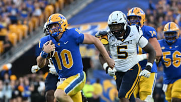 Sep 14, 2024; Pittsburgh, Pennsylvania, USA; Pittsburgh Panthers quarterback Eli Holstein (10) runs against West Virginia Mountaineers defensive lineman Sean Martin (5) during the fourth quarter at Acrisure Stadium. Mandatory Credit: Barry Reeger-Image Images