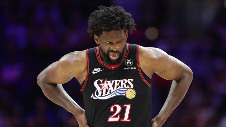 Feb 26, 2026; Philadelphia, Pennsylvania, USA; Philadelphia 76ers center Joel Embiid (21) reacts while clutching his body after a play against the Miami Heat during the second quarter at Xfinity Mobile Arena. Mandatory Credit: Bill Streicher-Imagn Images