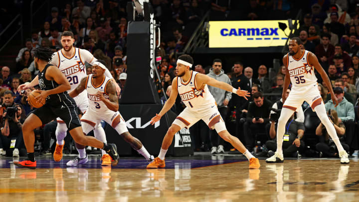 Dec 13, 2023; Phoenix, Arizona, USA; Phoenix Suns guard Bradley Beal (3), guard Devin Booker (1) and