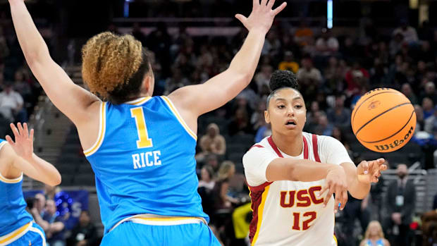 UCLA Bruins guard Kiki Rice (1) guards USC Trojans guard JuJu Watkins (12) as she passes the ball during the second half of t