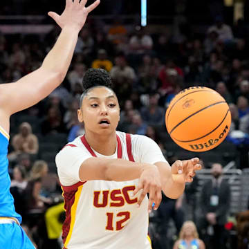 UCLA Bruins guard Kiki Rice (1) guards USC Trojans guard JuJu Watkins (12) as she passes the ball during the second half of the 2025 TIAA Big Ten Women's Basketball Tournament final game on Sunday, March 9, 2025, at Gainbridge Fieldhouse in Indianapolis. UCLA defeated USC 72-67.