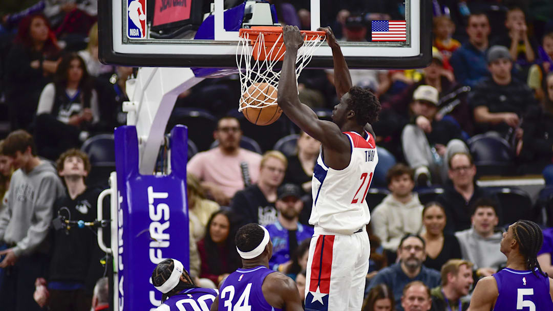 Mar 19, 2025; Salt Lake City, Utah, USA;  Washington Wizards forward JT Thor (21) makes a dunk against Utah Jazz guard Jordan Clarkson (00) and Utah Jazz forward/center Oscar Tshiebwe (34) during the second half at the Delta Center. Mandatory Credit: Peter Creveling-Imagn Images