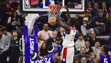 Mar 19, 2025; Salt Lake City, Utah, USA;  Washington Wizards forward JT Thor (21) makes a dunk against Utah Jazz guard Jordan Clarkson (00) and Utah Jazz forward/center Oscar Tshiebwe (34) during the second half at the Delta Center. Mandatory Credit: Peter Creveling-Imagn Images
