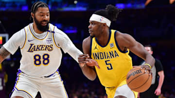Feb 8, 2025; Los Angeles, California, USA; Indiana Pacers forward Jarace Walker (5) moves the ball against Los Angeles Lakers forward Markieff Morris (88) during the first half at Crypto.com Arena. Mandatory Credit: Gary A. Vasquez-Imagn Images