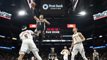 Apr 12, 2024; San Antonio, Texas, USA; San Antonio Spurs forward Victor Wembanyama (1) goes up to dunk over Denver Nuggets guard Kentavious Caldwell-Pope (5) and  forward Michael Porter Jr. (1) during the first half at Frost Bank Center.