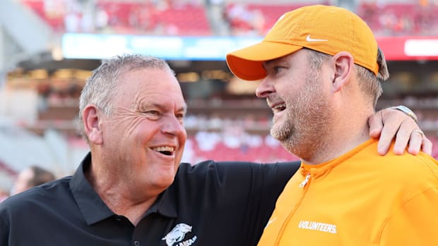 Razorbacks coach Sam Pittman talks to Tennessee coach Josh Heupel 