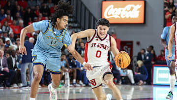 Nov 3, 2025; Queens, New York, USA;  St. John's basketball guard Dylan Darling (0) drives past Quinnipiac Bobcats forward Braylan Ritvo (13) in the second half at Carnesecca Arena.