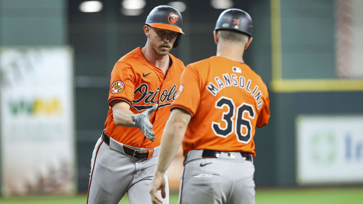 Jun 22, 2024; Houston, Texas, USA; Baltimore Orioles second baseman Jordan Westburg (11) celebrates with third base coach Tony Mansolino (36) after hitting a home run during the second inning against the Houston Astros at Minute Maid Park