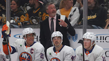 Oct 9, 2025; Pittsburgh, Pennsylvania, USA;  New York Islanders head coach Patrick Roy (rear) gestures on the bench against the Pittsburgh Penguins during the third period at PPG Paints Arena. Mandatory Credit: Charles LeClaire-Imagn Images