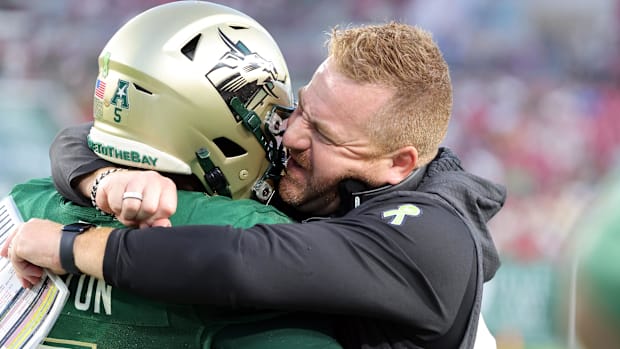 South Florida Bulls running back Cartevious Norton is congratulated by South Florida Bulls head coach Alex Golesh.