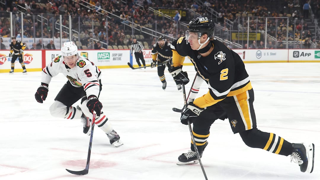 Apr 8, 2025; Pittsburgh, Pennsylvania, USA;  Pittsburgh Penguins right wing Rutger McGroarty (2) shoots the puck as Chicago Blackhawks defenseman Connor Murphy (5) defends during the first period at PPG Paints Arena. Mandatory Credit: Charles LeClaire-Imagn Images