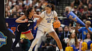 Apr 4, 2025; Tampa, FL, USA;  UCLA Bruins center Lauren Betts (51) dribbles against Connecticut Huskies center Jana El Alfy (8) during the third quarter in a semifinal of the women's 2025 NCAA tournament at Amalie Arena. Mandatory Credit: Nathan Ray Seebeck-Imagn Images