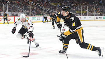 Apr 8, 2025; Pittsburgh, Pennsylvania, USA;  Pittsburgh Penguins right wing Rutger McGroarty (2) shoots the puck as Chicago Blackhawks defenseman Connor Murphy (5) defends during the first period at PPG Paints Arena. Mandatory Credit: Charles LeClaire-Imagn Images