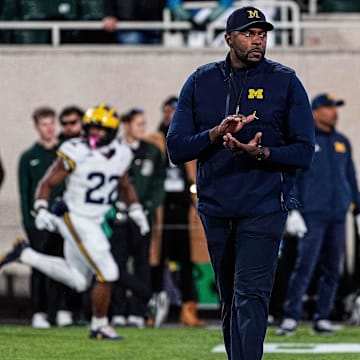 Michigan head coach Sherrone Moore watches warm up at Spartan Stadium in East Lansing on Saturday, October 25, 2025.