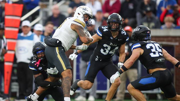 Oct 10, 2026; Atlanta, Georgia, USA; Georgia Tech Yellow Jackets tight end Gavin Harris (8) is tackled by Duke Blue Devils cornerback Kyon Loud (1) and linebacker Luke Mergott (34) and safety Andrew Pellicciotta (35) in the second quarter at Bobby Dodd Stadium at Hyundai Field. Mandatory Credit: Brett Davis-Imagn Images