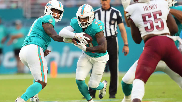 Miami Dolphins quarterback Tua Tagovailoa (1) hands off to running back Raheem Mostert (31) against the Washington Commanders during the first quarter of the preseason game at Hard Rock Stadium.